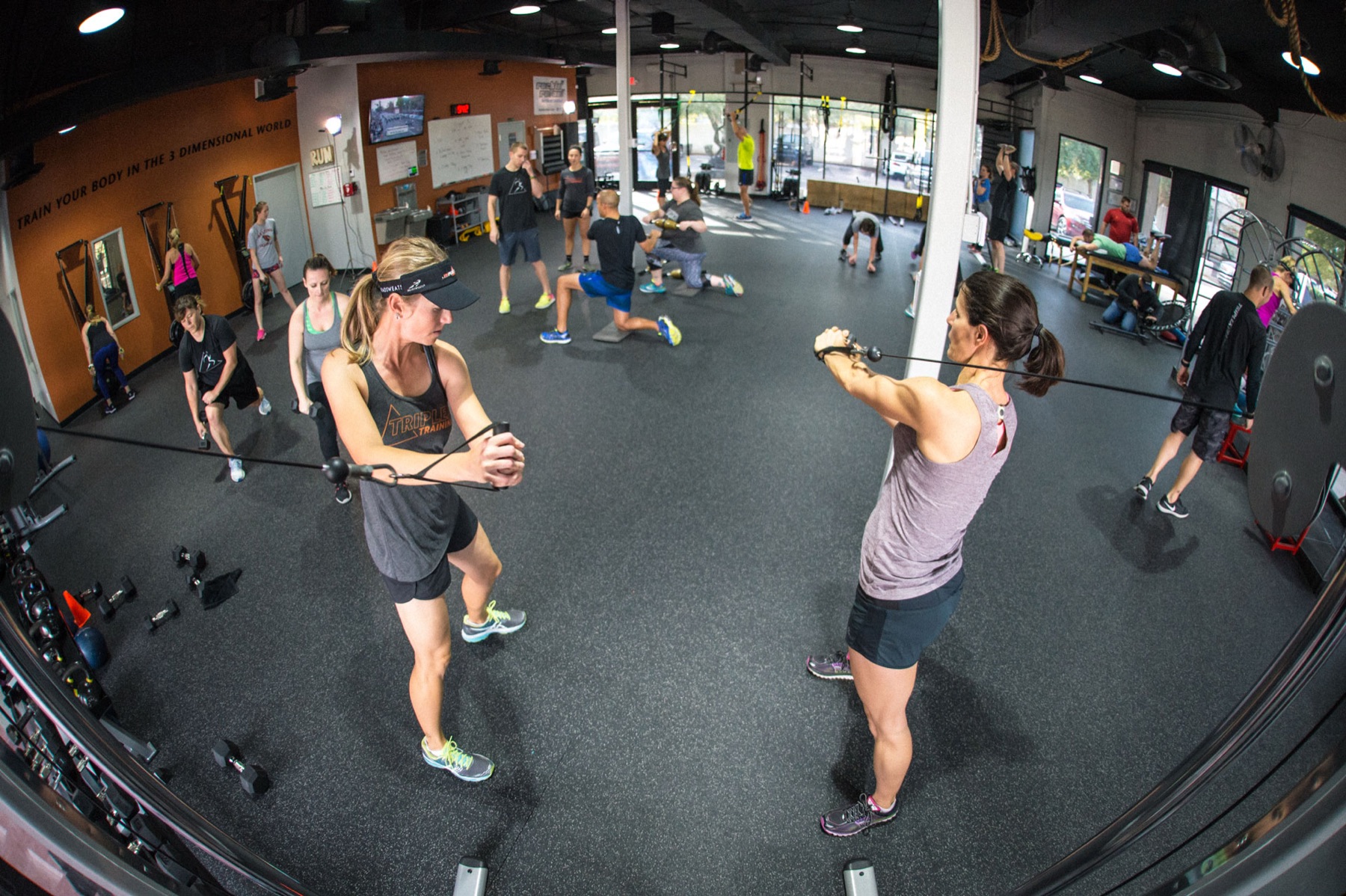 A Triplex group training class working through a full-body circuit